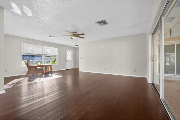 a view of a livingroom with furniture wooden floor and a window