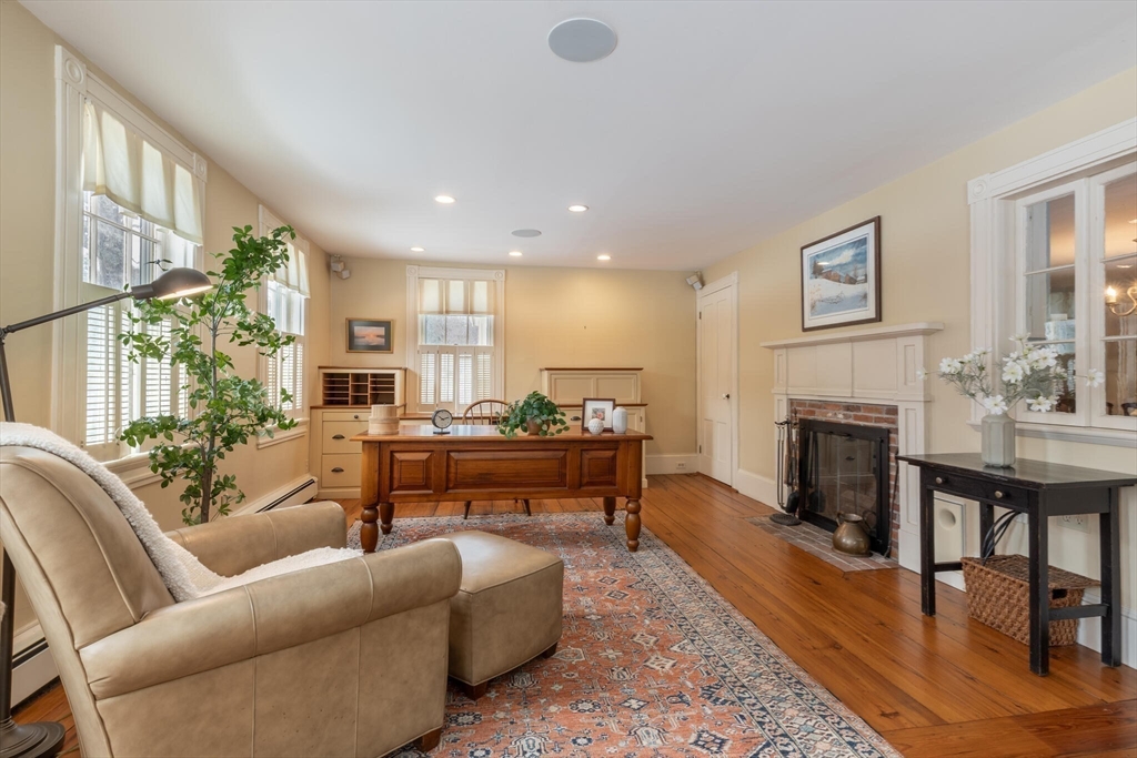 520 Dutton Road Sudbury, MA 01776 - Photo 26 of 42 a living room with furniture a fireplace and a table
