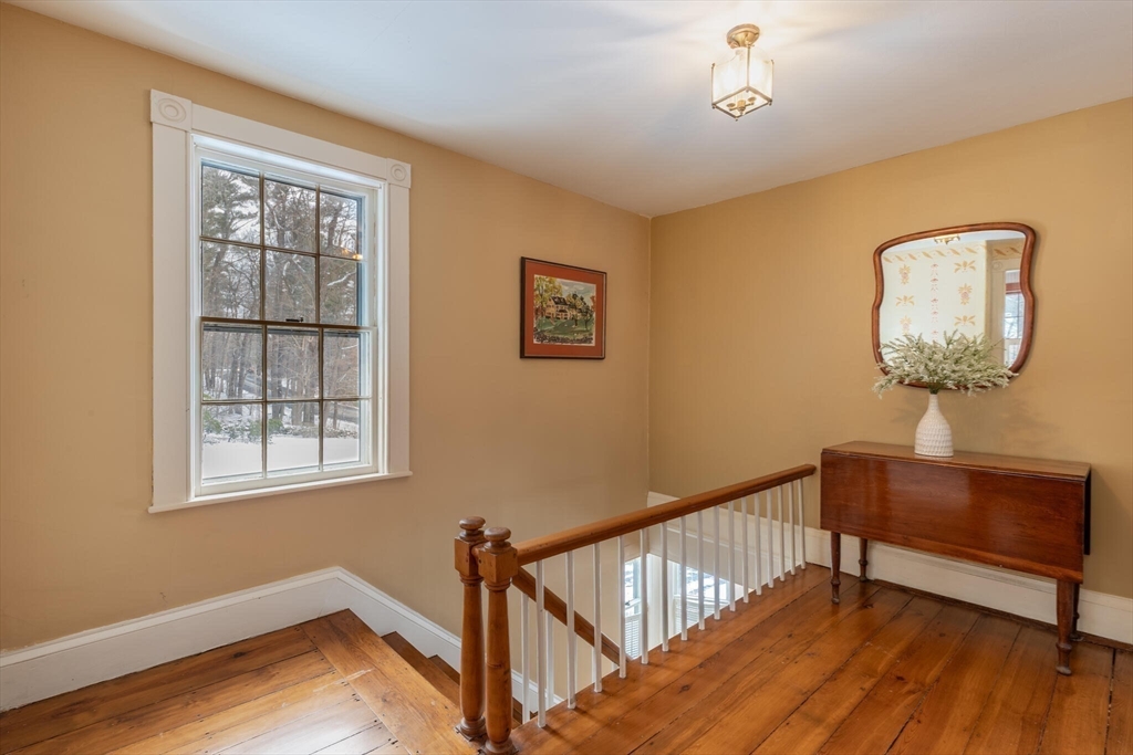 520 Dutton Road Sudbury, MA 01776 - Photo 29 of 42 a view of a hallway with wooden floor and staircase
