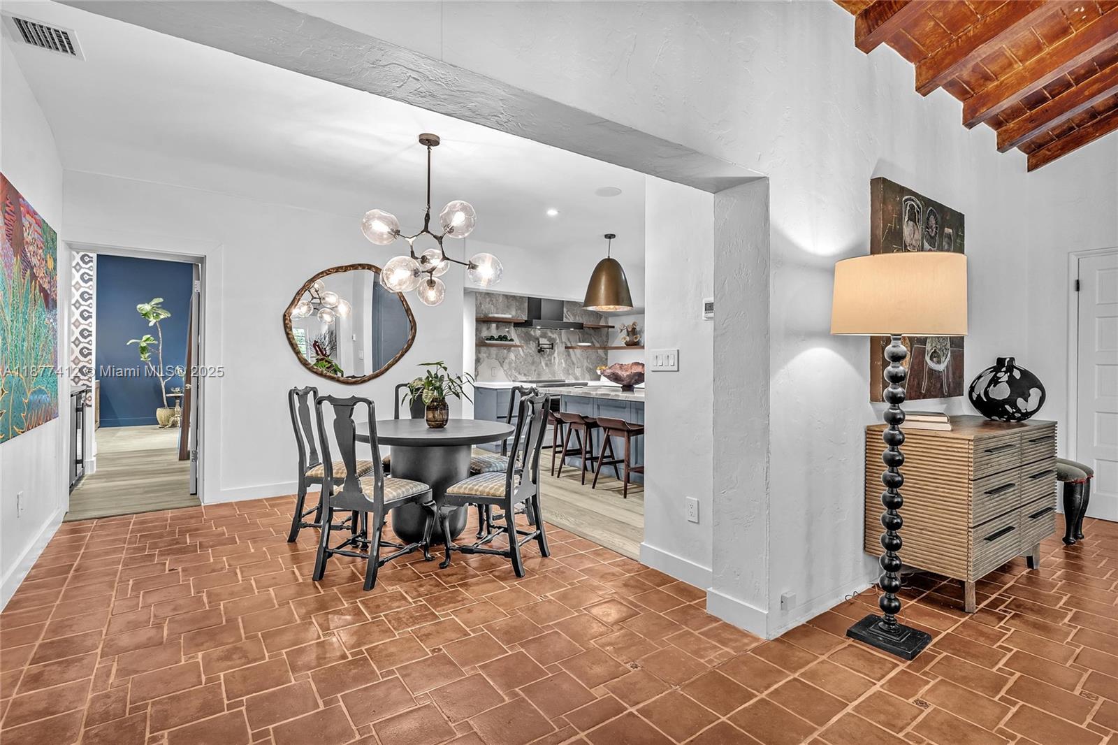 856 Tyler Street Hollywood, FL 33019 - Photo 13 of 52 a view of a dining room with furniture and chandelier