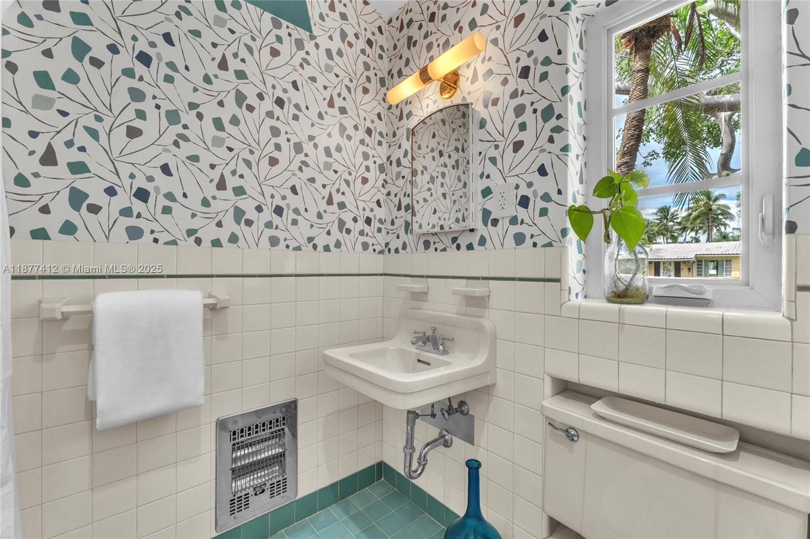 856 Tyler Street Hollywood, FL 33019 - Photo 41 of 52 a bathroom with a sink and a mirror