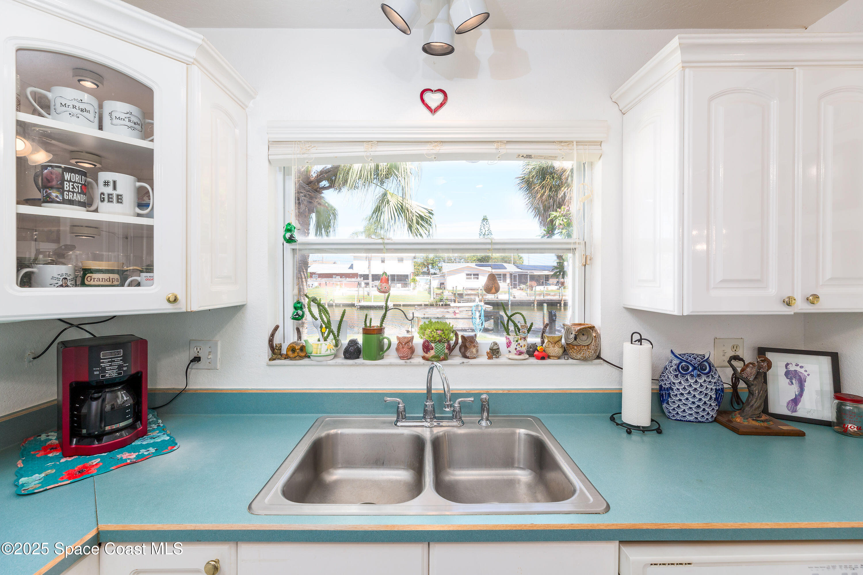 1135 Audubon Road Merritt Island, FL 32953 - Photo 14 of 52 a kitchen with a window wooden floor and a window