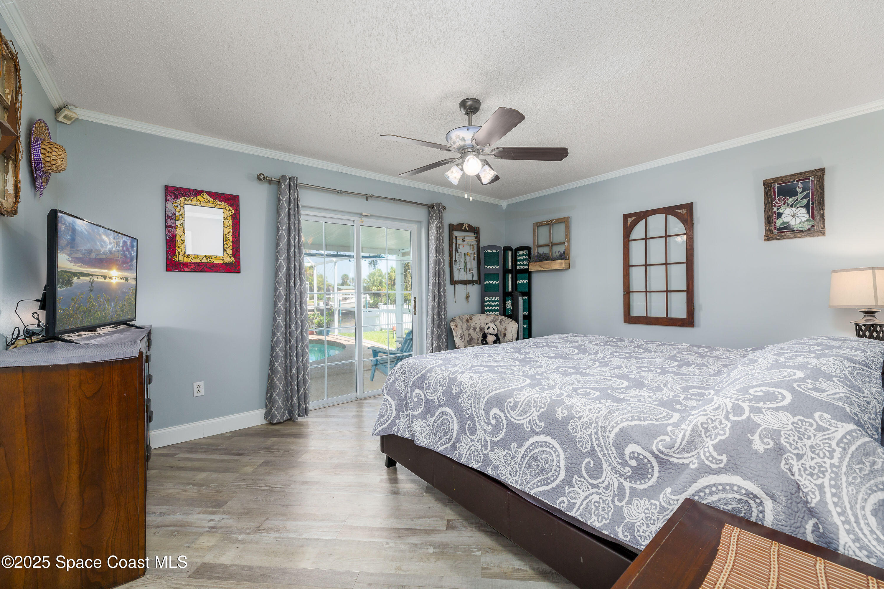 1135 Audubon Road Merritt Island, FL 32953 - Photo 16 of 52 a bedroom with a bed and a flat screen tv