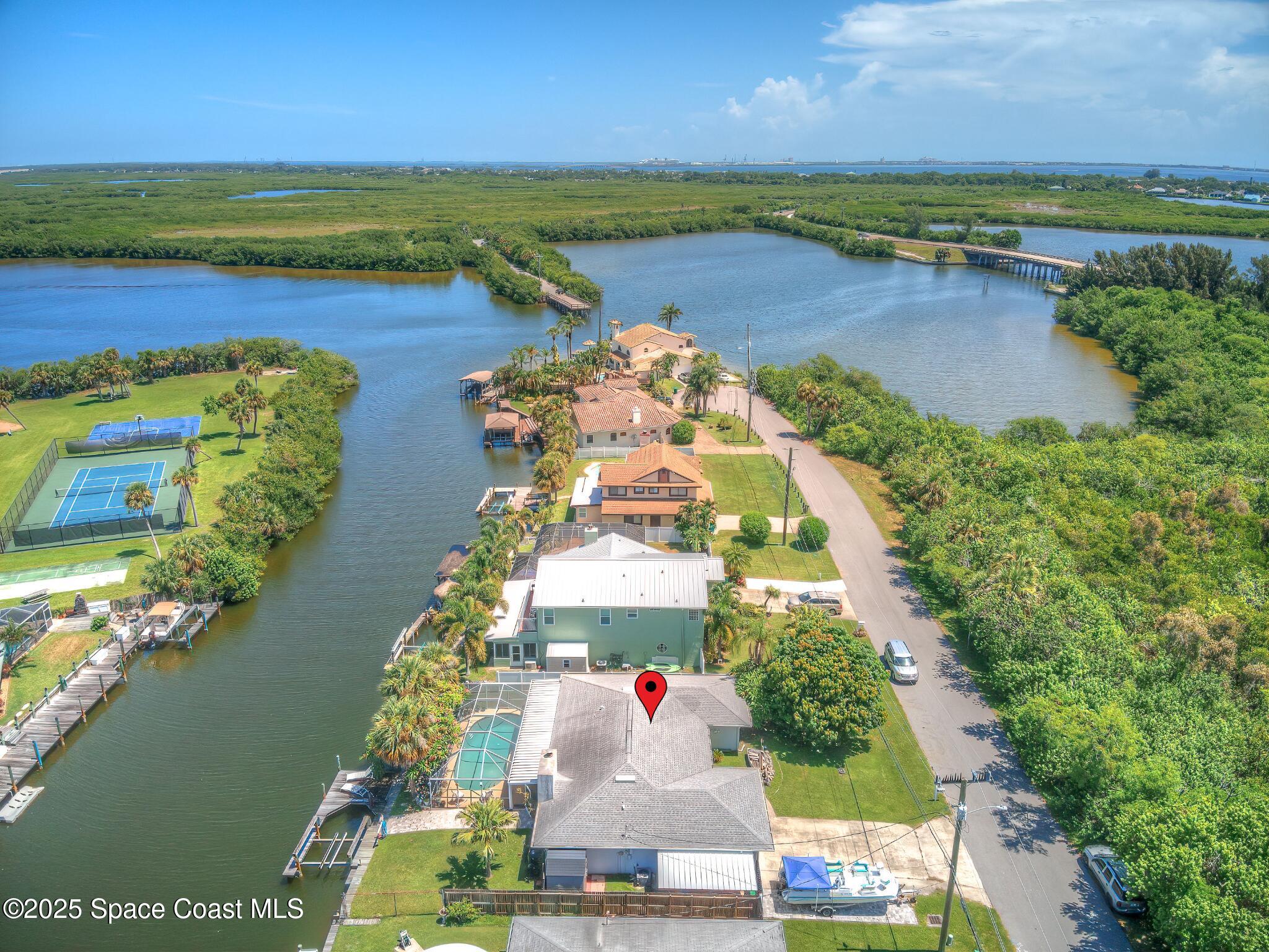 1135 Audubon Road Merritt Island, FL 32953 - Photo 2 of 52 an aerial view of ocean and residential houses with outdoor space