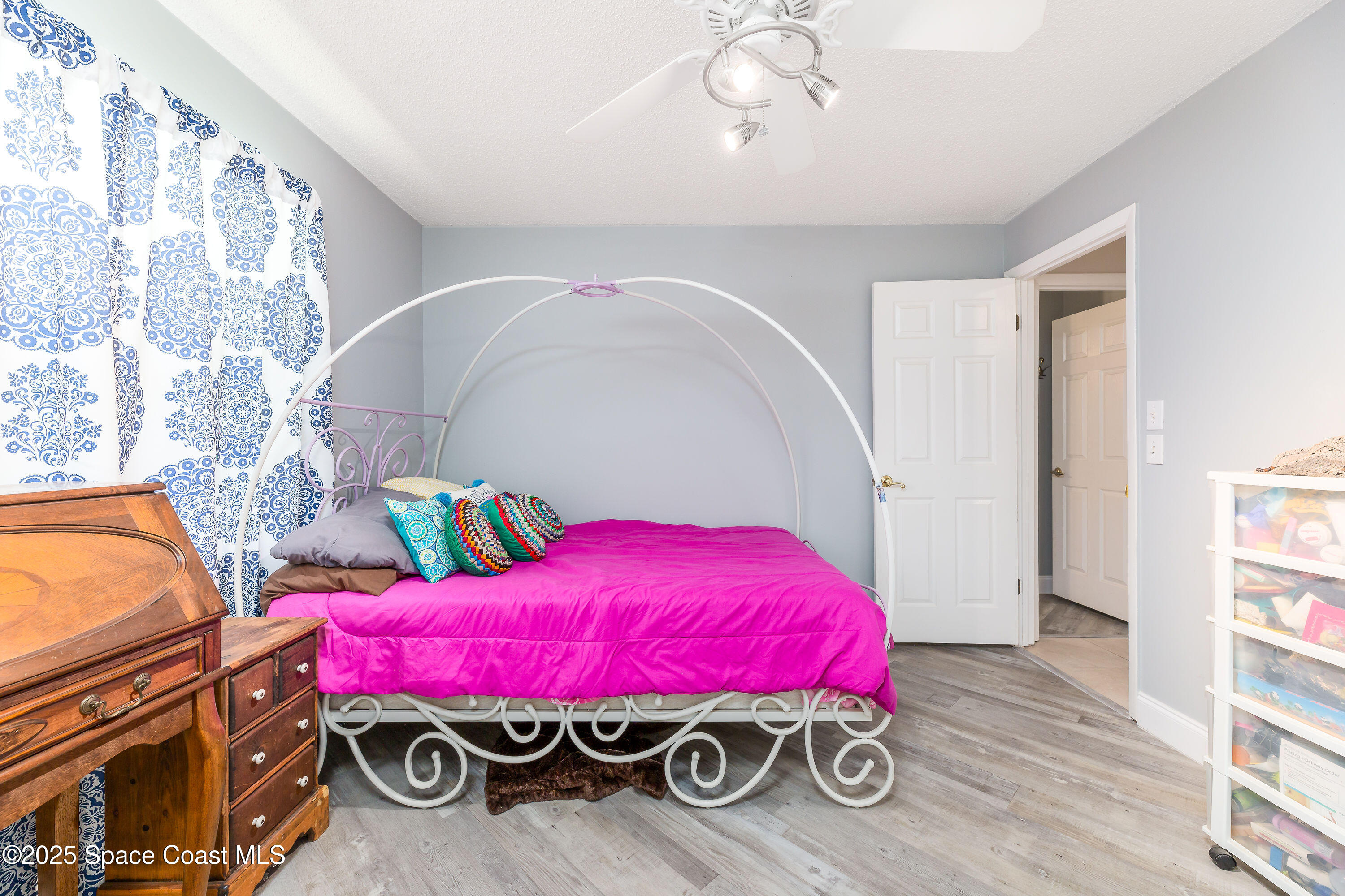 1135 Audubon Road Merritt Island, FL 32953 - Photo 23 of 52 a bedroom with furniture and a chandelier