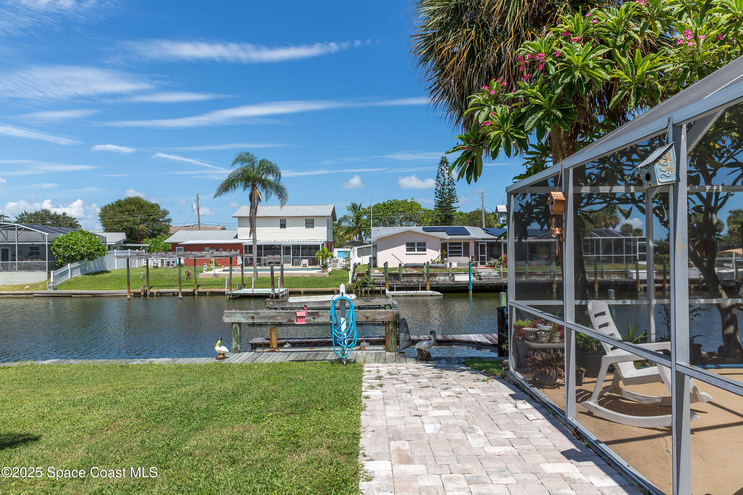 1135 Audubon Road Merritt Island, FL 32953 - Photo 30 of 52 a view of a lake with a floor to ceiling window next to a yard