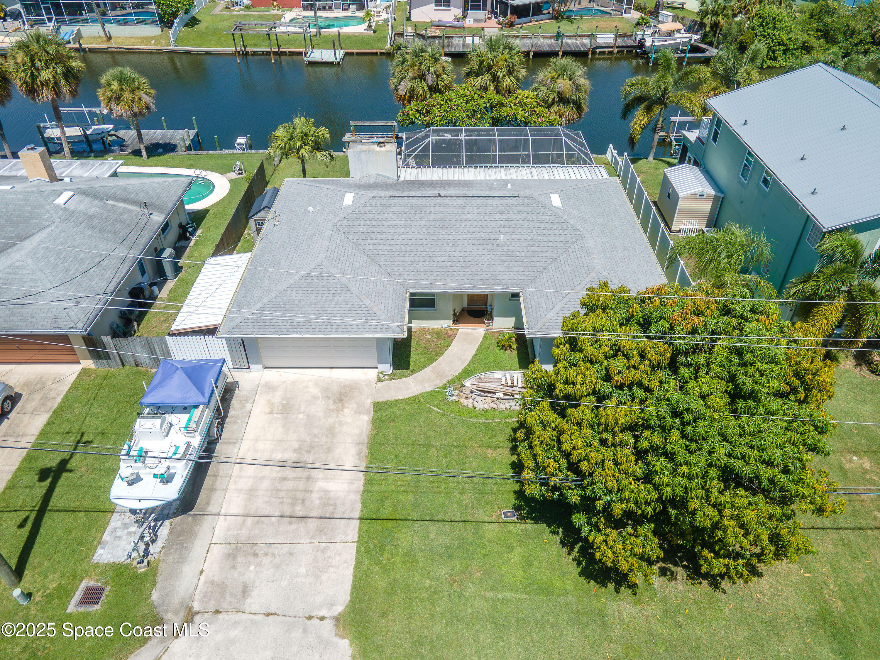 1135 Audubon Road Merritt Island, FL 32953 - Photo 38 of 52 an aerial view of a house with a garden and lake view