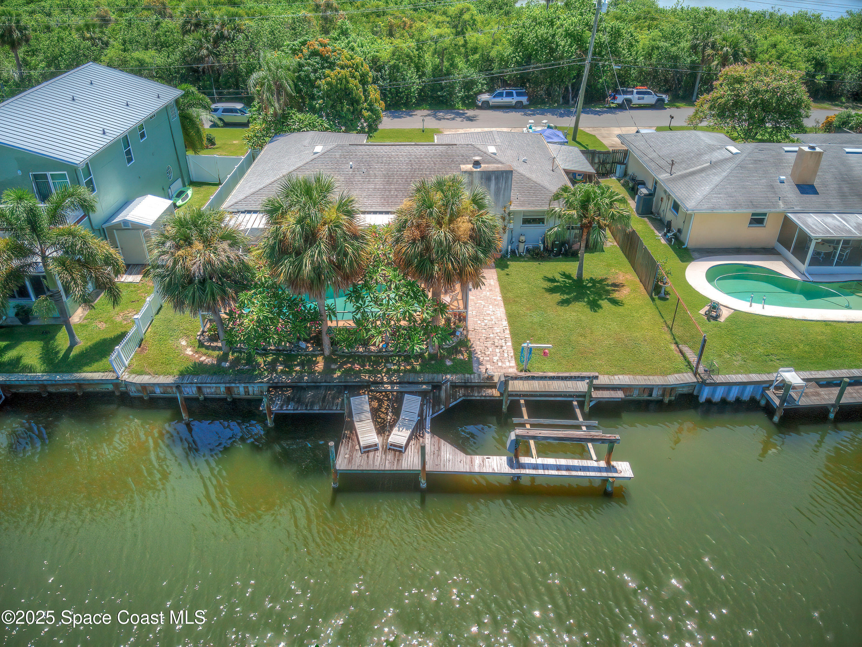 1135 Audubon Road Merritt Island, FL 32953 - Photo 41 of 52 a view of a swimming pool with a table and chairs