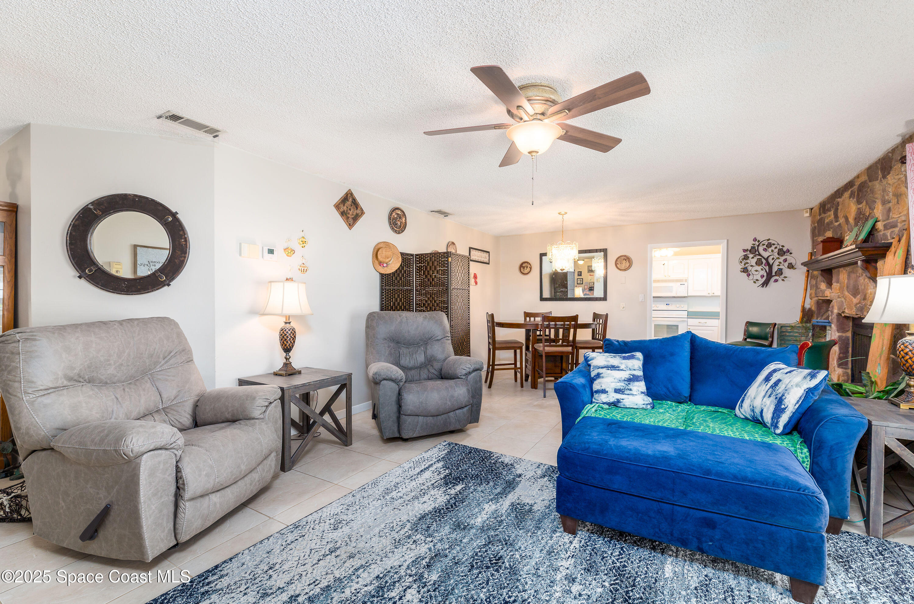 1135 Audubon Road Merritt Island, FL 32953 - Photo 8 of 52 a living room with furniture and a large window