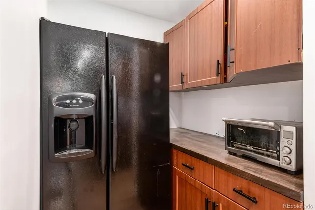 a kitchen with stainless steel appliances granite countertop a refrigerator and a stove