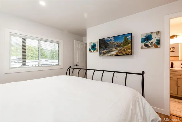 a bed sitting in a bedroom next to a window