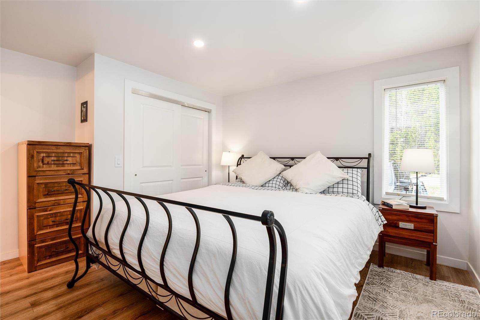 192 Little Creek Road Idaho Springs, CO 80452 - Photo 14 of 24 a bedroom with a bed and wooden floor