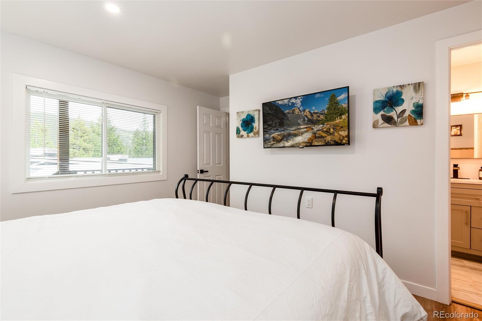 192 Little Creek Road Idaho Springs, CO 80452 - Photo 15 of 24 a bed sitting in a bedroom next to a window