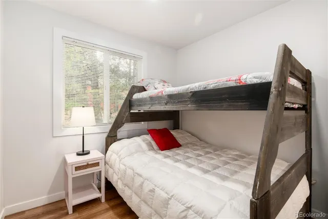 a bedroom with a bed and a large mirror