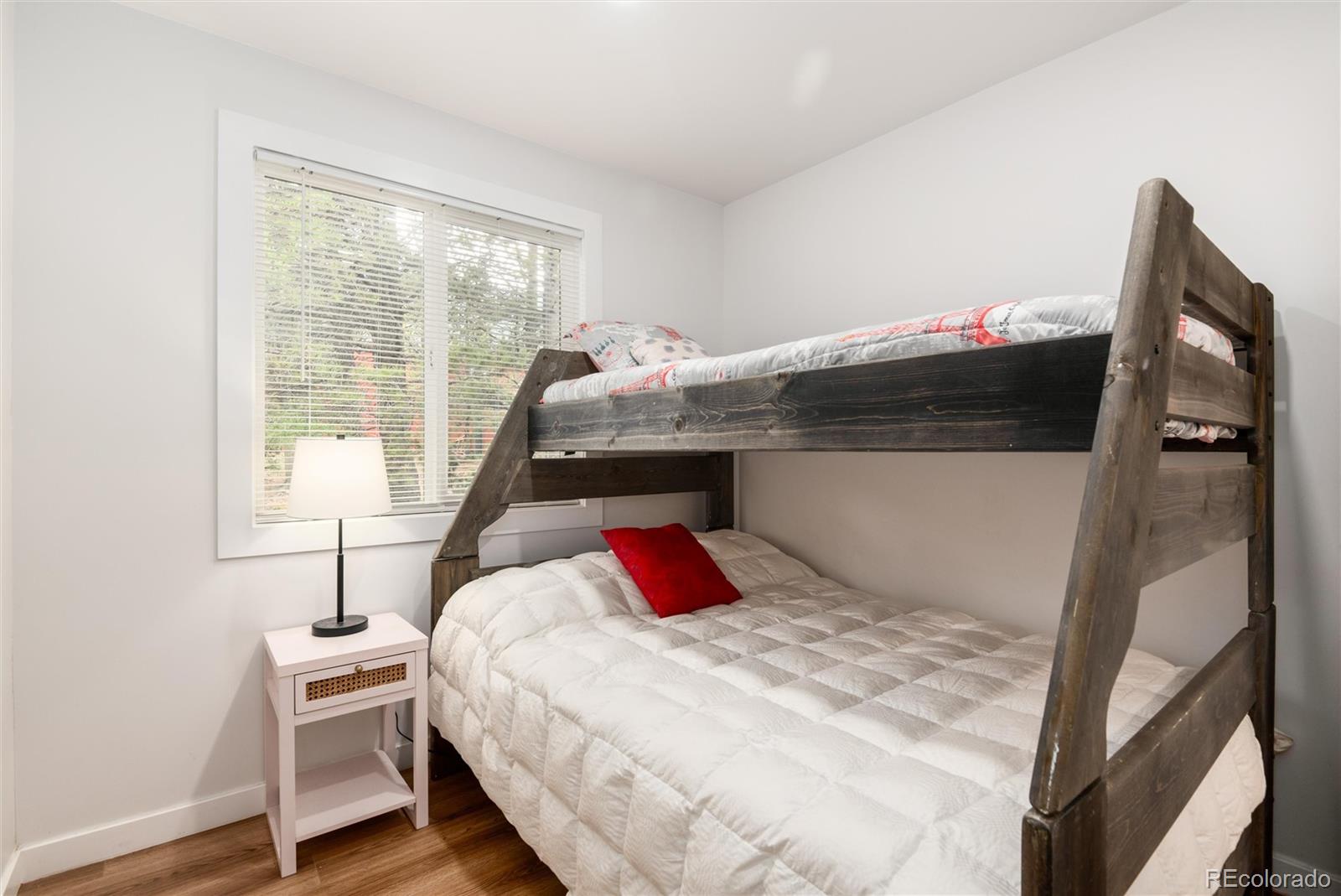 192 Little Creek Road Idaho Springs, CO 80452 - Photo 18 of 24 a bedroom with a bed and a large mirror