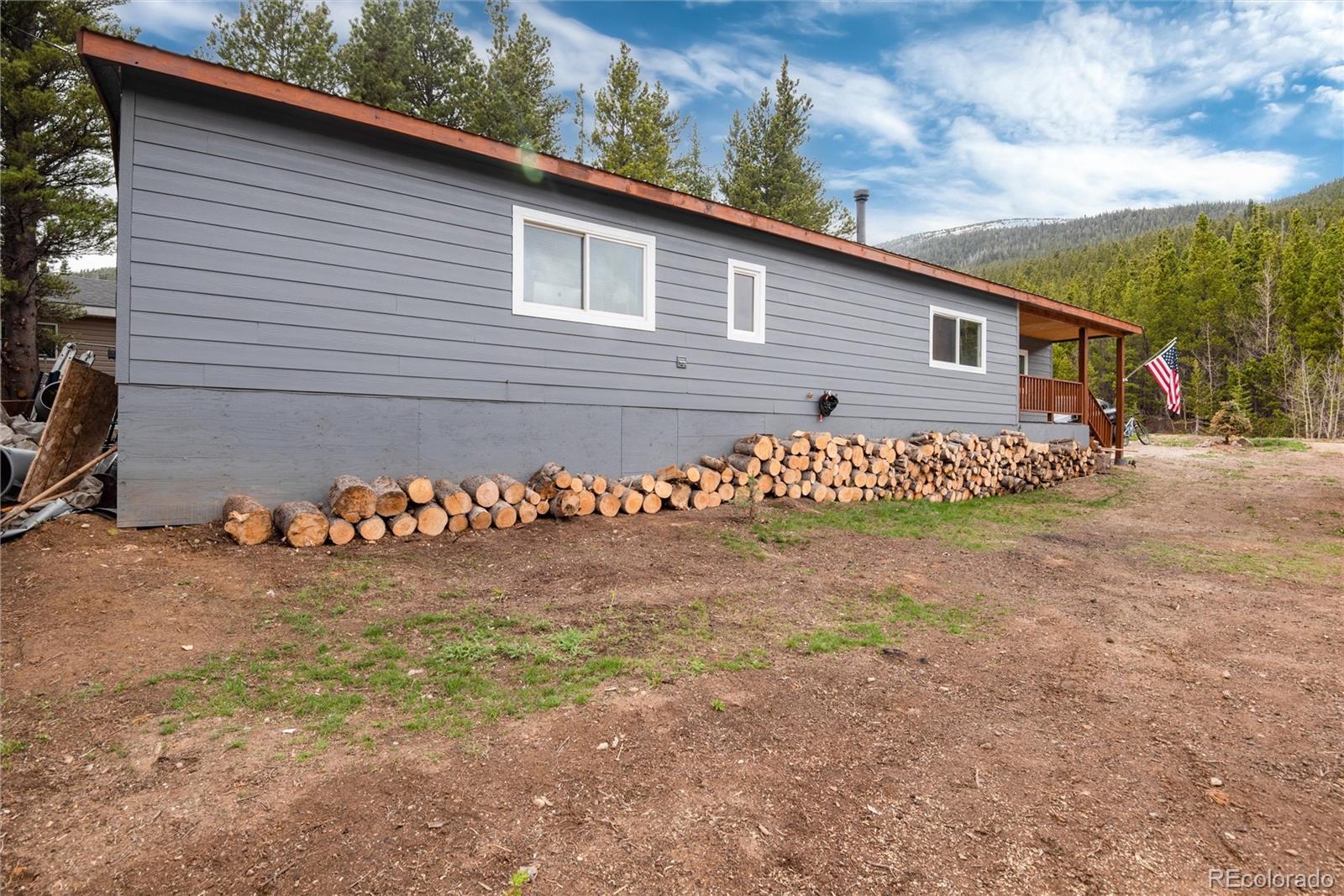 192 Little Creek Road Idaho Springs, CO 80452 - Photo 22 of 24 a view of a wooden house with a yard