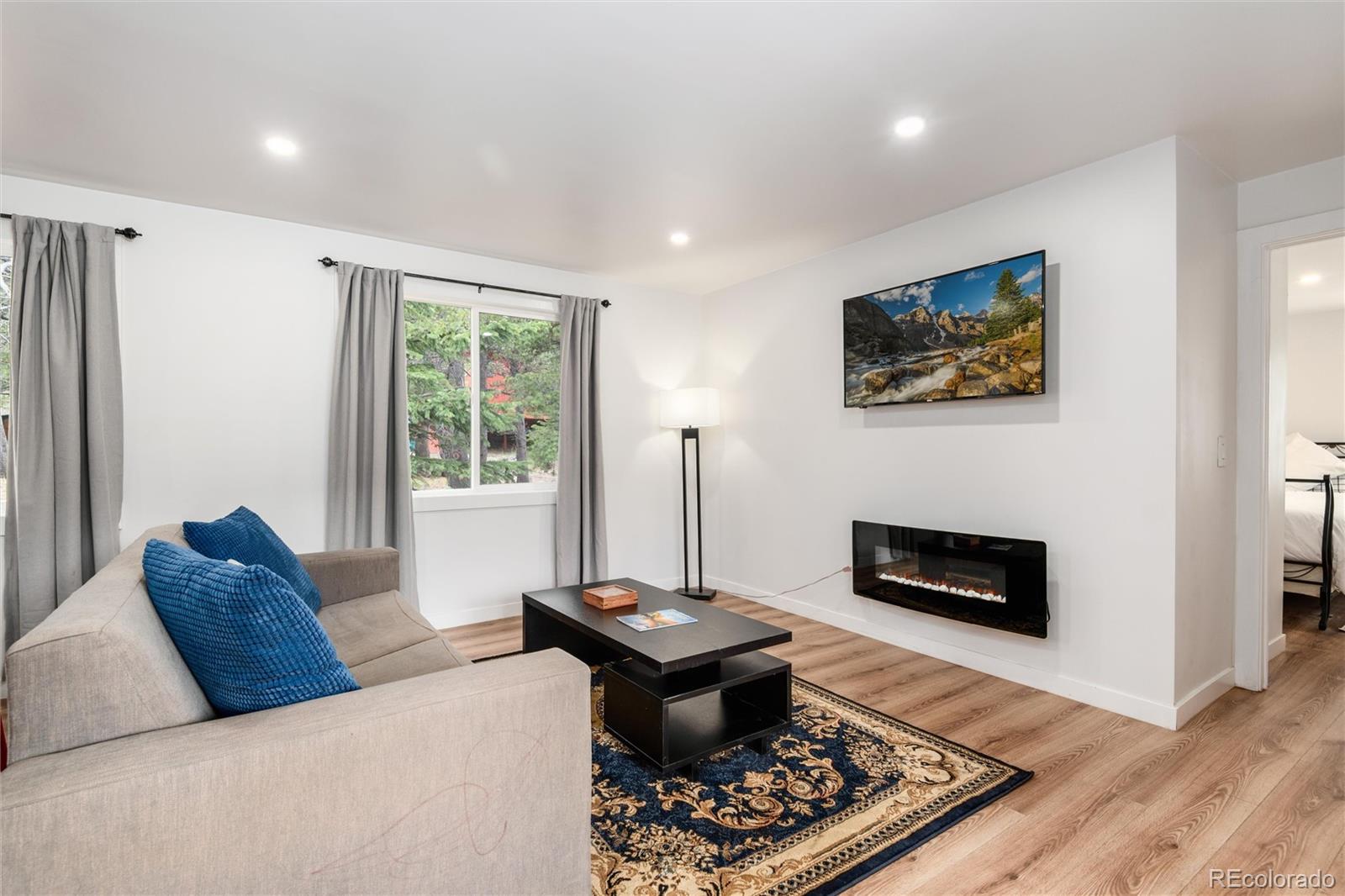 192 Little Creek Road Idaho Springs, CO 80452 - Photo 5 of 24 a living room with furniture and a fireplace