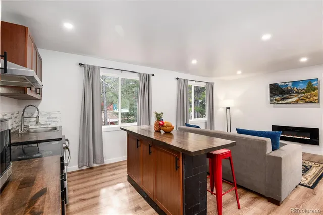a kitchen with counter top space a sink and appliances