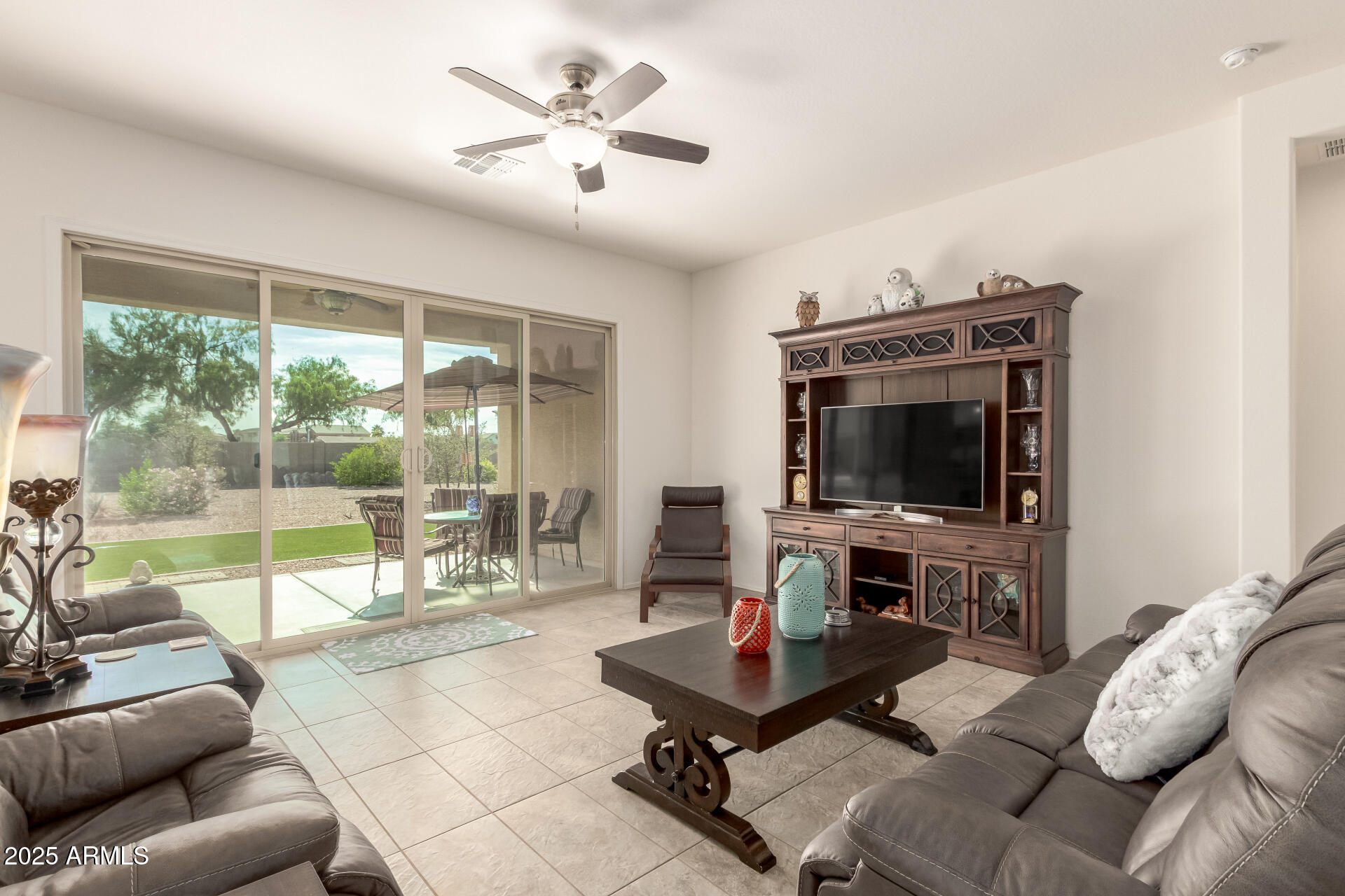 42851 West Mallard Road Maricopa, AZ 85138 - Photo 11 of 45 a living room with furniture a flat screen tv and a large window