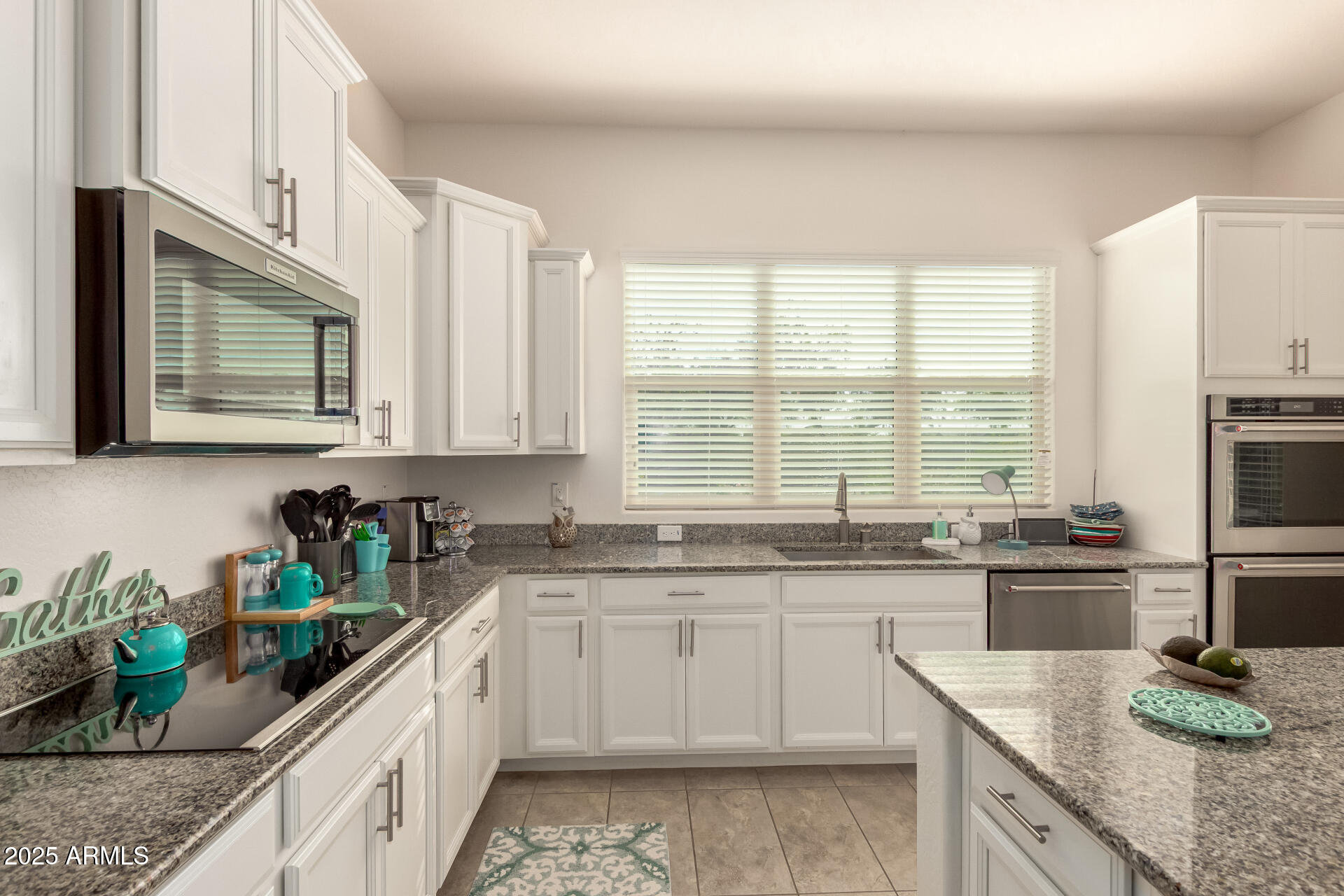 42851 West Mallard Road Maricopa, AZ 85138 - Photo 19 of 45 a kitchen with stainless steel appliances granite countertop sink stove top oven and microwave