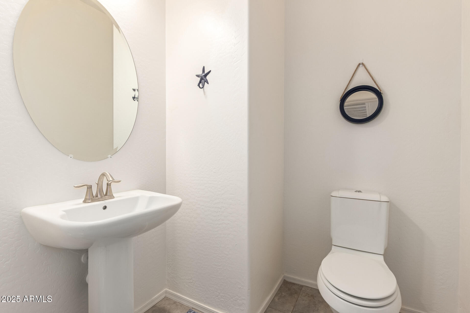42851 West Mallard Road Maricopa, AZ 85138 - Photo 20 of 45 a bathroom with a toilet sink and mirror