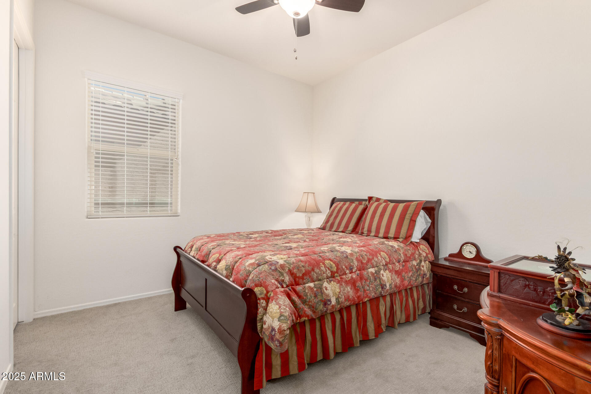 42851 West Mallard Road Maricopa, AZ 85138 - Photo 32 of 45 a bed room with a bed and a chandelier