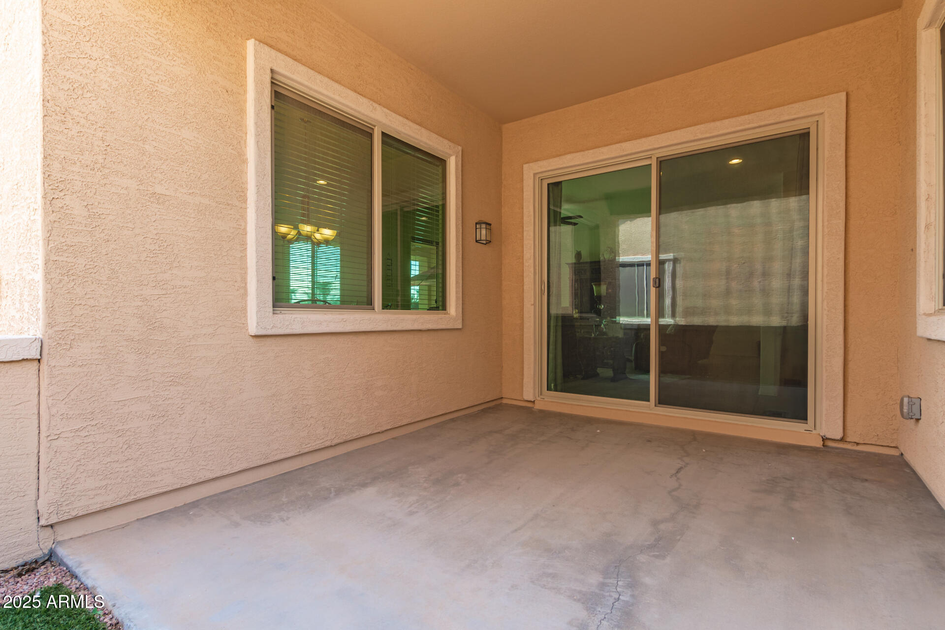 42851 West Mallard Road Maricopa, AZ 85138 - Photo 38 of 45 an empty room with sliding glass door and windows