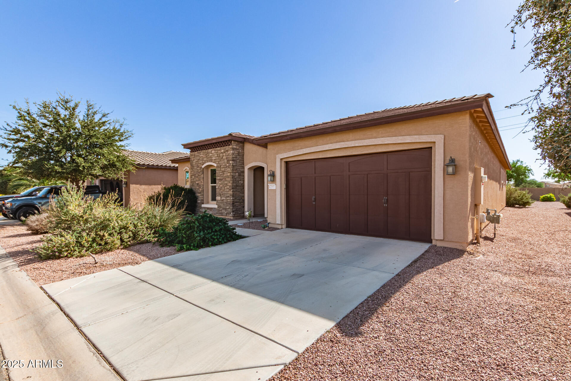 42851 West Mallard Road Maricopa, AZ 85138 - Photo 5 of 45 a front view of a house with a yard and garage