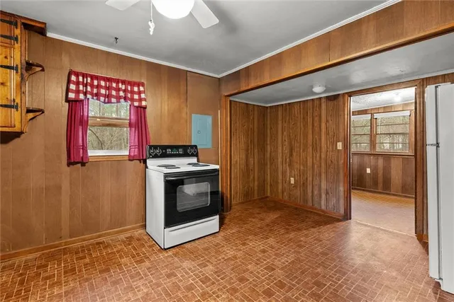 a view of an empty room with a fireplace and a window