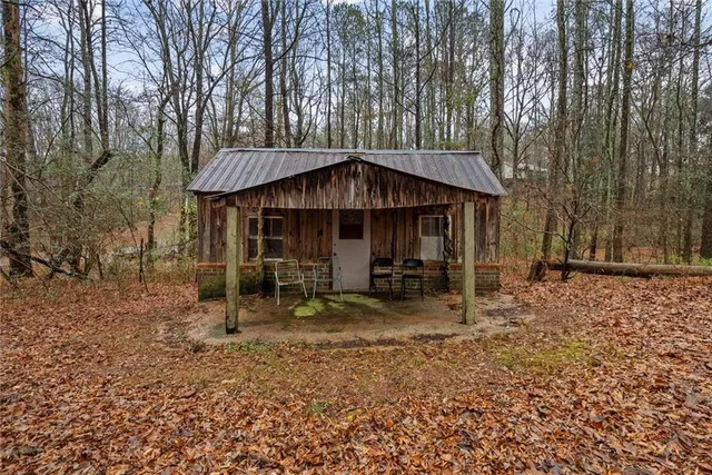 a view of a house with a yard and sitting area