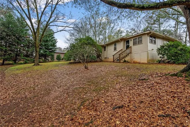 a view of a backyard with large trees