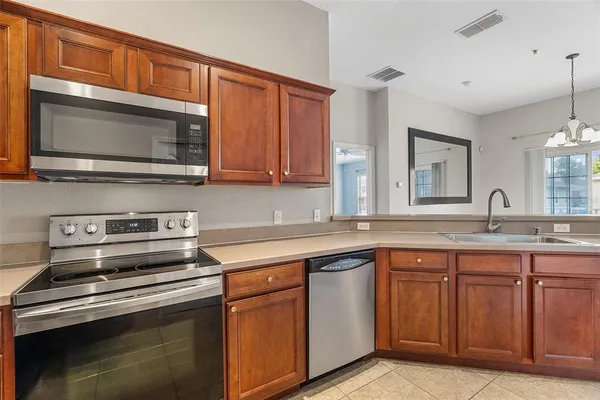 a kitchen with a sink and a mirror