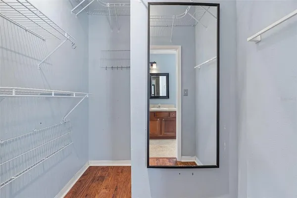 a en suite bathroom with a granite countertop sink and a mirror