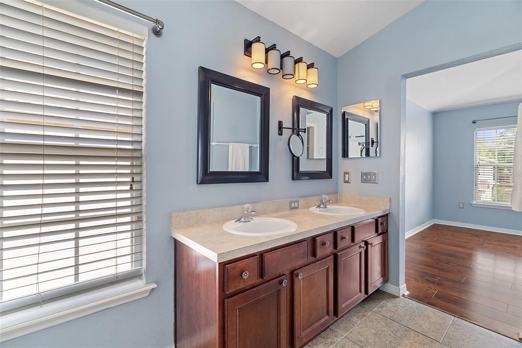 3555 Clay Brick Road, Unit 46A Harmony, FL 34773 - Photo 18 of 54 a en suite bathroom with a granite countertop sink and a mirror