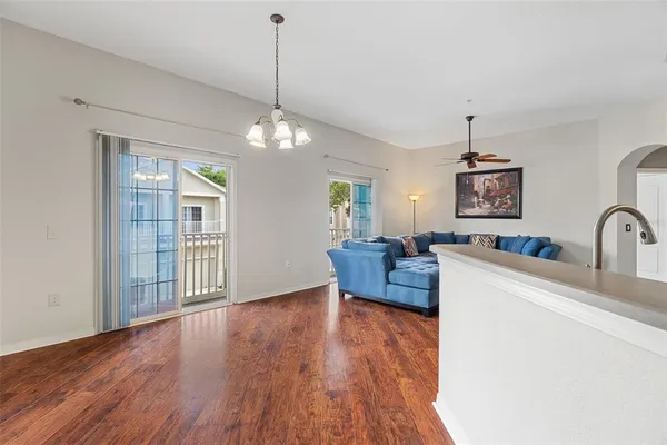a living room with furniture and a chandelier