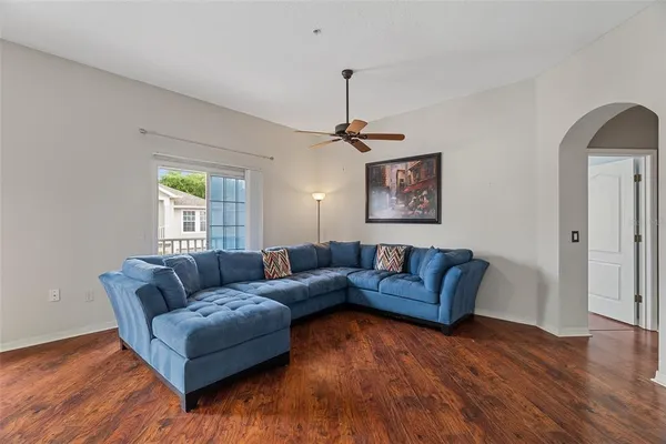 a living room with furniture and a wooden floor