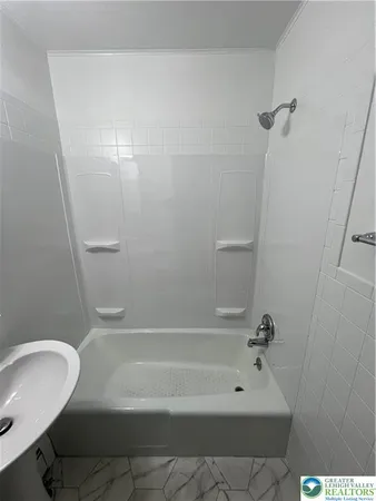 a bathroom with a bathtub and shower