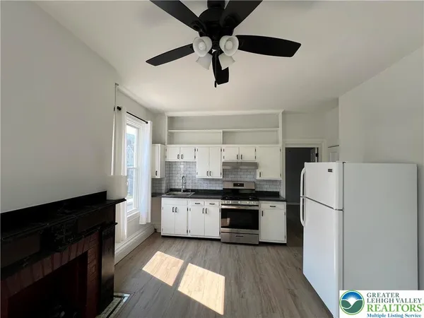 a kitchen with stainless steel appliances a stove a refrigerator and a sink
