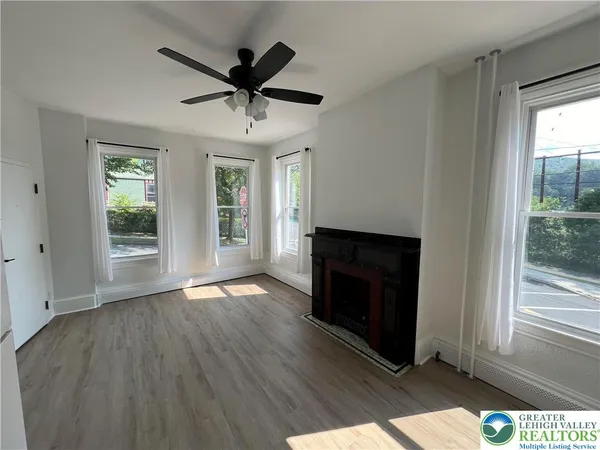 a view of wooden floor and a fireplace in a room