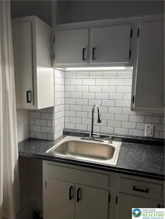 a kitchen with a sink and cabinets