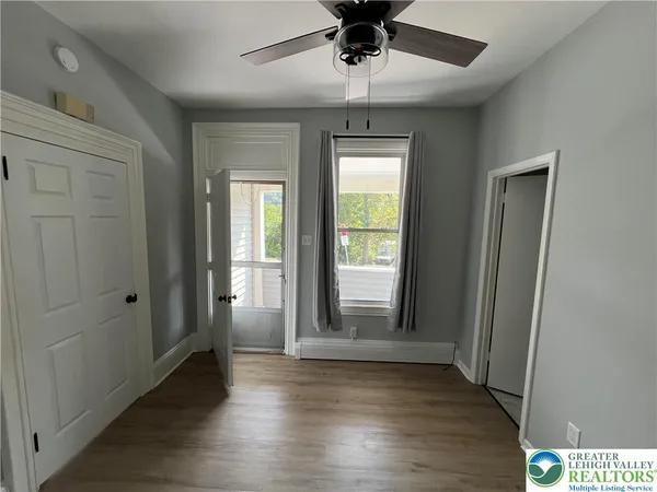wooden floor in an empty room with a window