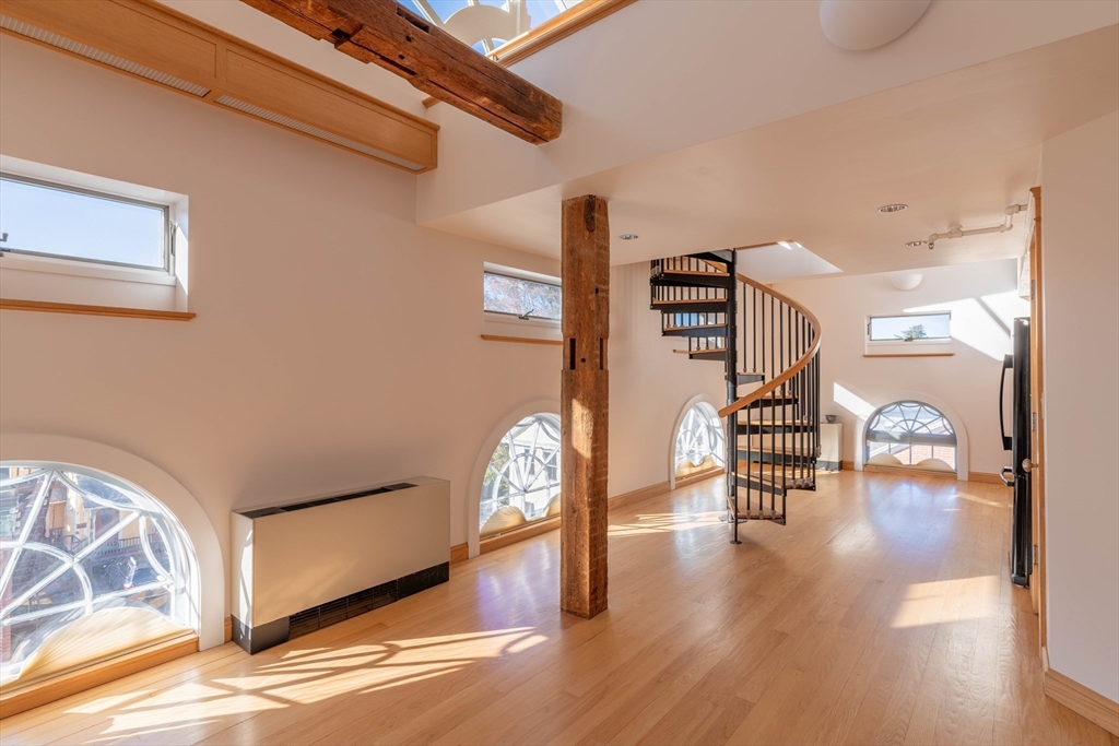 a view of an entryway with wooden floor
