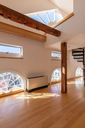 a view of a room with wooden floor