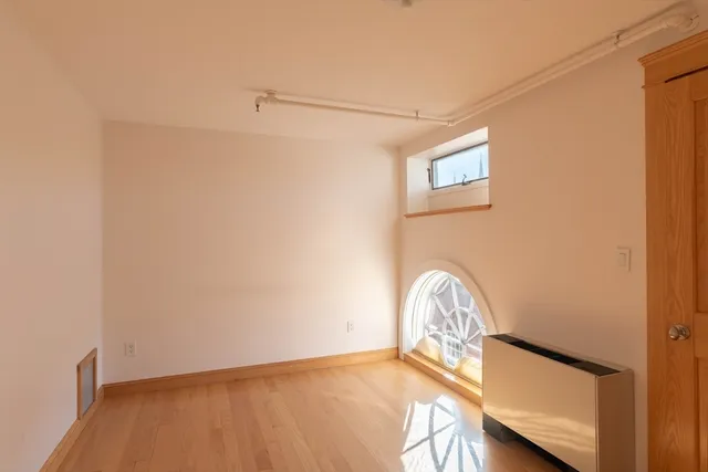 a view of staircase with railing and white walls