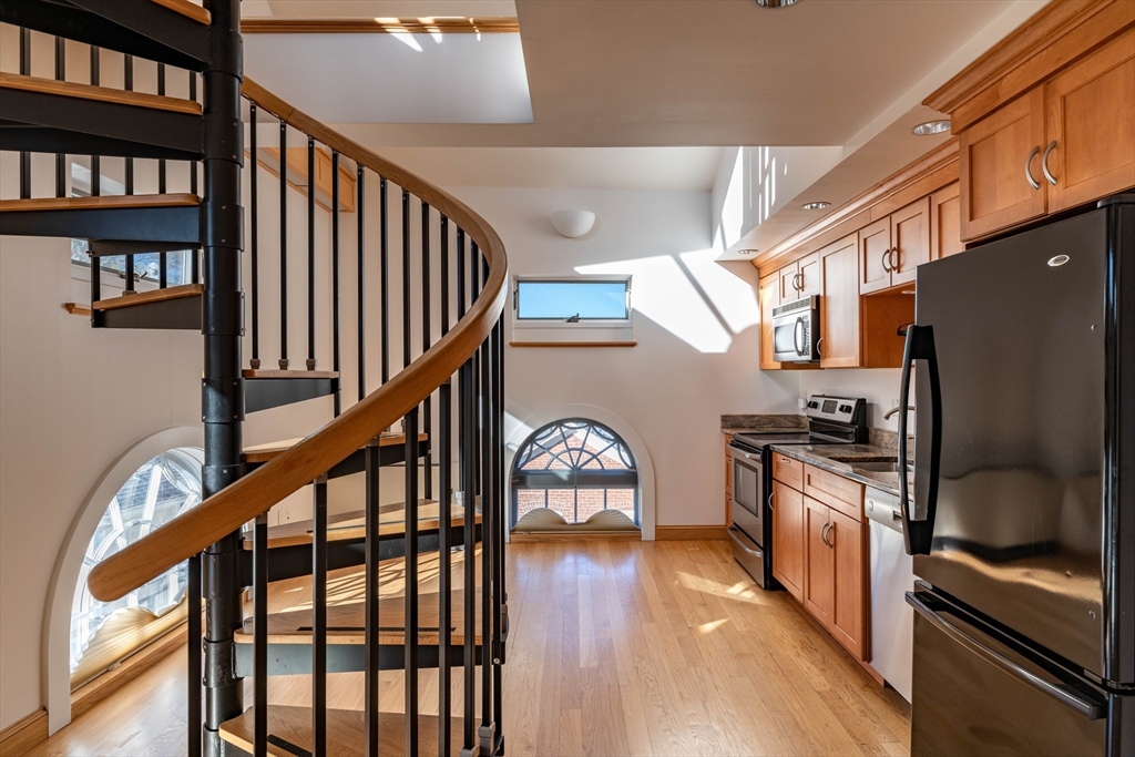 43 Center Street, Unit K Northampton, MA 01060 - Photo 6 of 18 a dining room with wooden floor and stairs