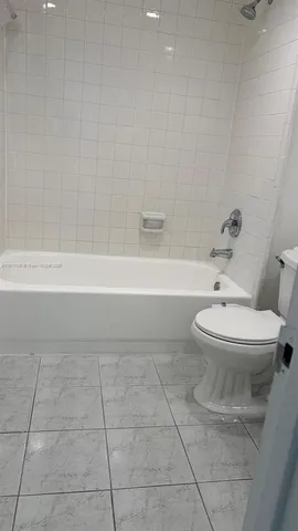a bathroom with a toilet and a bathtub
