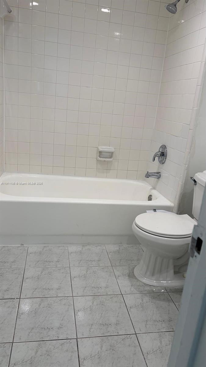 7925 Fairview Drive, Unit 110 Tamarac, FL 33321 - Photo 11 of 34 a bathroom with a toilet and a bathtub