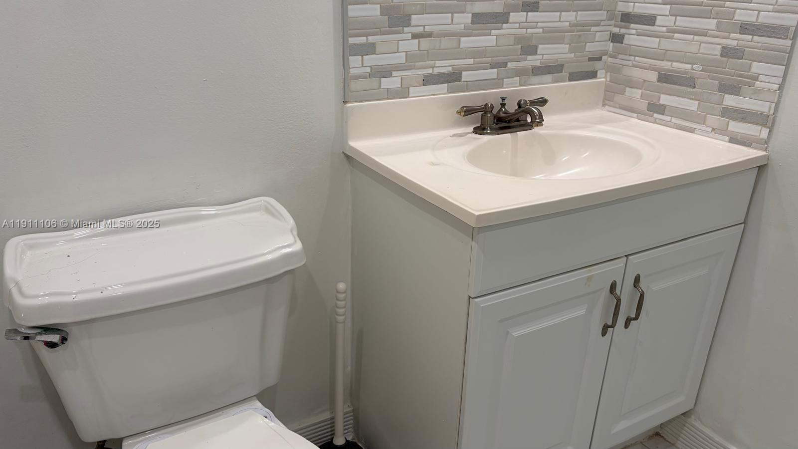 7925 Fairview Drive, Unit 110 Tamarac, FL 33321 - Photo 12 of 34 a bathroom with a sink and mirror