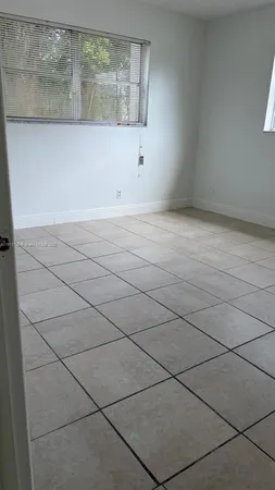 an empty room with a empty space and a window