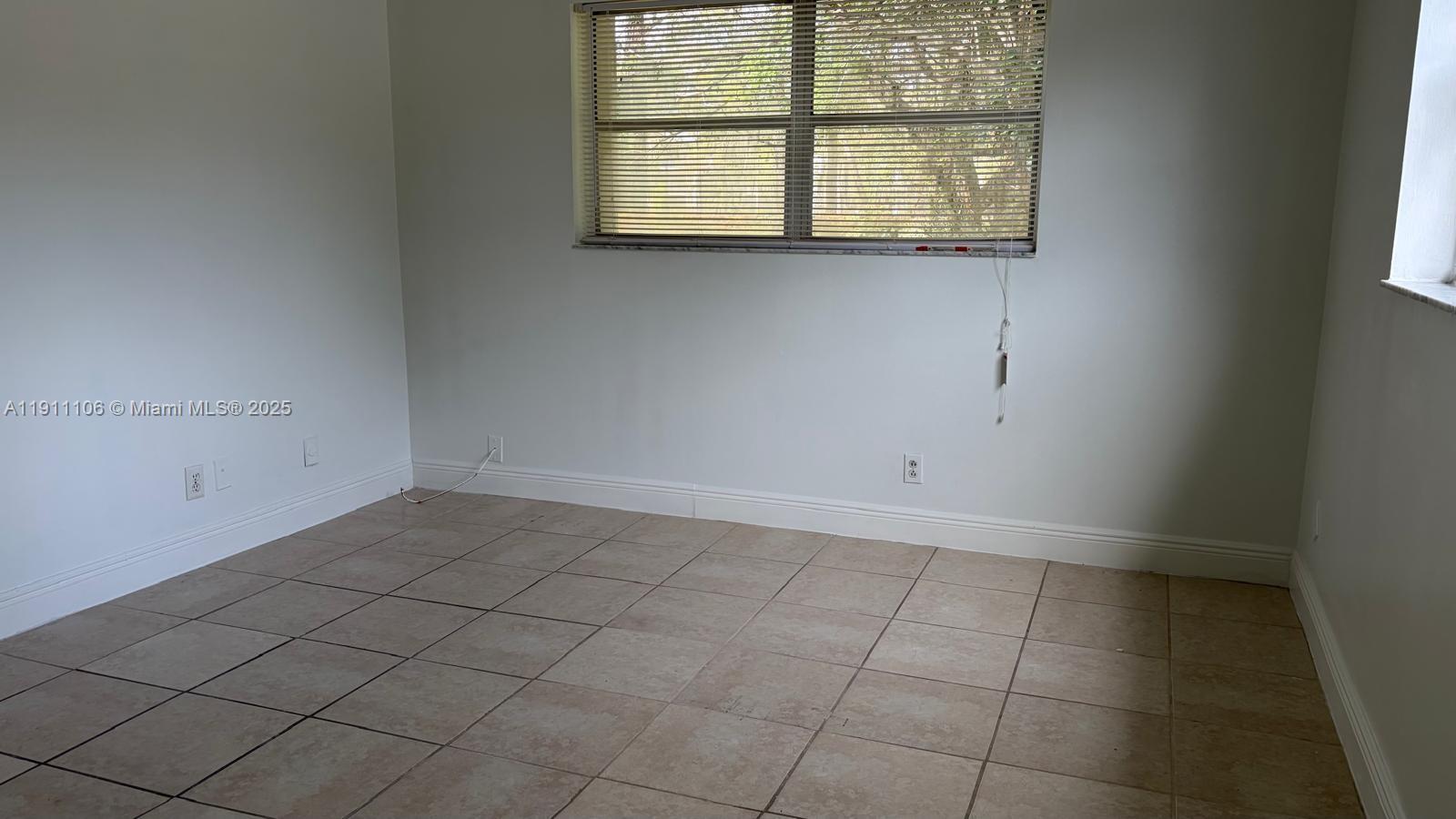 7925 Fairview Drive, Unit 110 Tamarac, FL 33321 - Photo 14 of 34 an empty room with a window